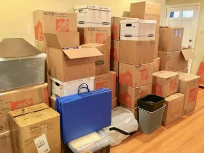 Boxes packed in preparation for a move from a house to a condo